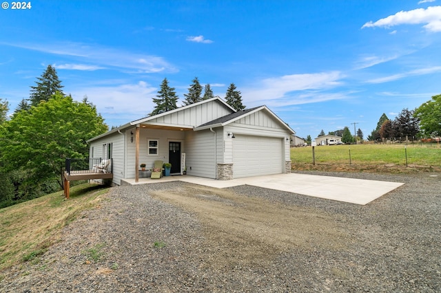 ranch-style house with a garage and a deck