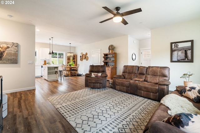 living room with ceiling fan and dark wood-type flooring