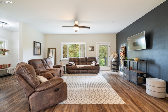 living room with ceiling fan and dark wood-type flooring