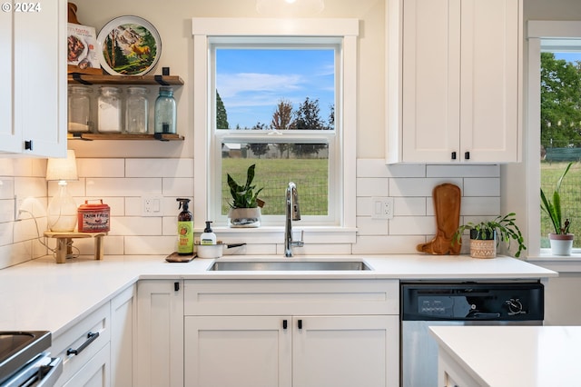 kitchen featuring decorative backsplash, dishwasher, sink, and white cabinets