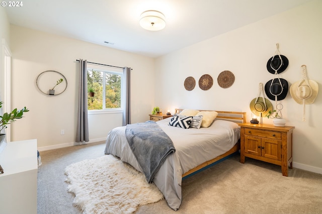 bedroom featuring light carpet