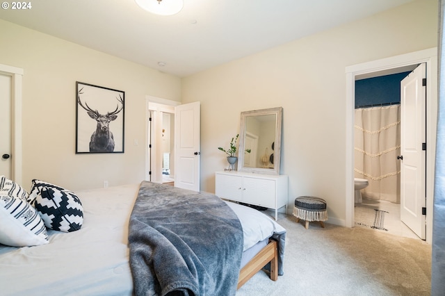 carpeted bedroom with ensuite bathroom