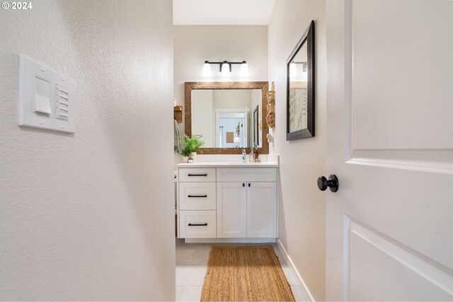 bathroom with tile patterned flooring and vanity