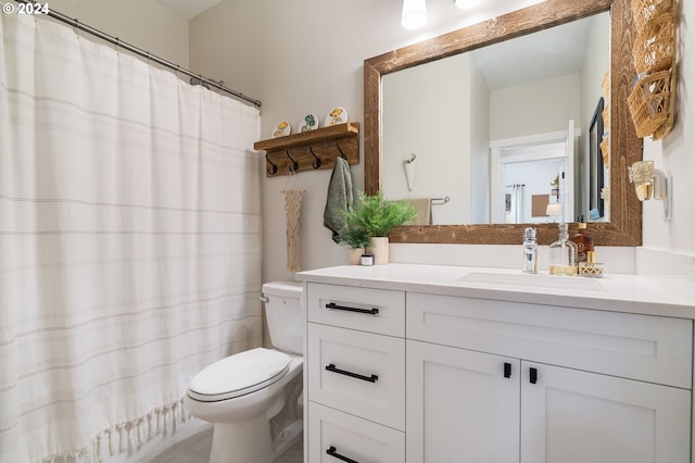 bathroom with tile patterned flooring, vanity, and toilet