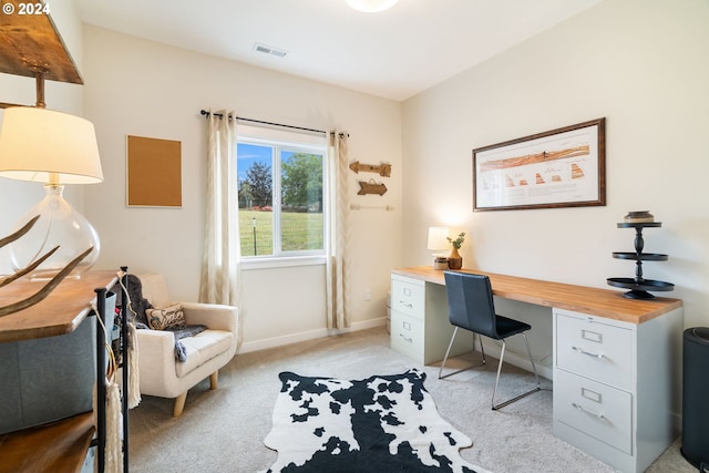 office area with light carpet and built in desk