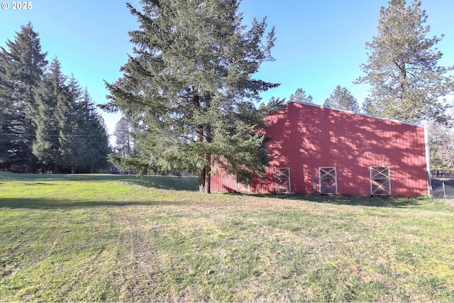 view of yard with an outbuilding and a barn