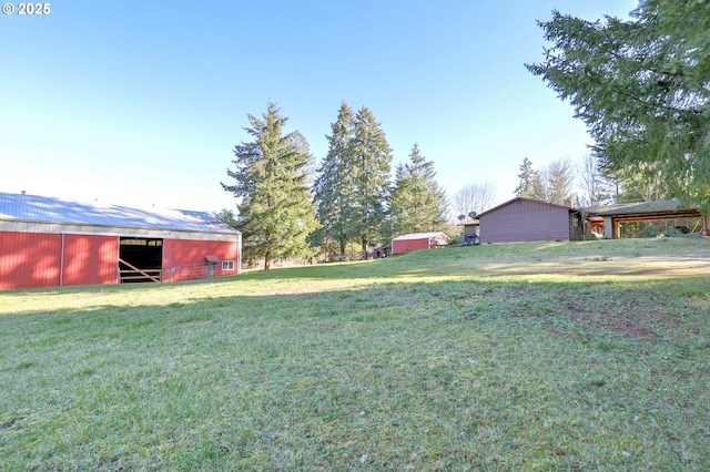 view of yard with a pole building and an outbuilding