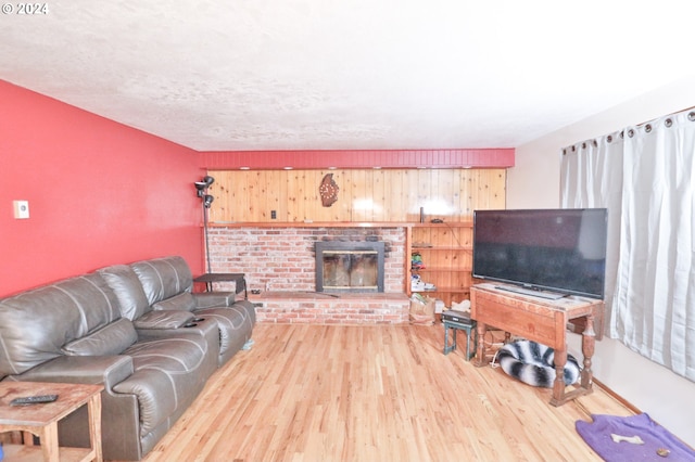 living area with a fireplace and wood finished floors