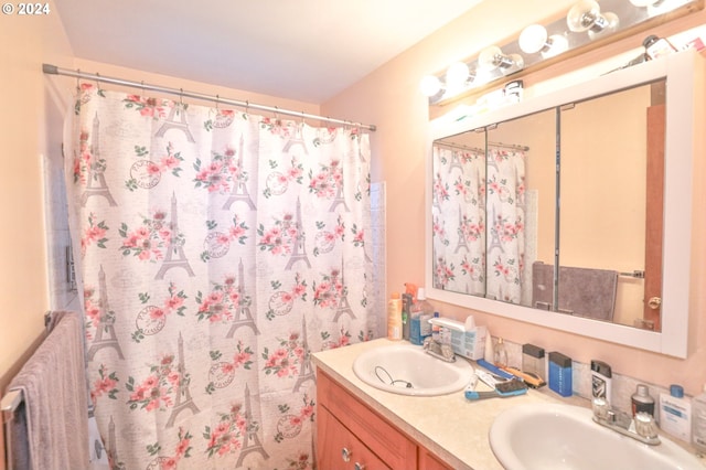 full bath featuring double vanity, a shower with curtain, a sink, and radiator