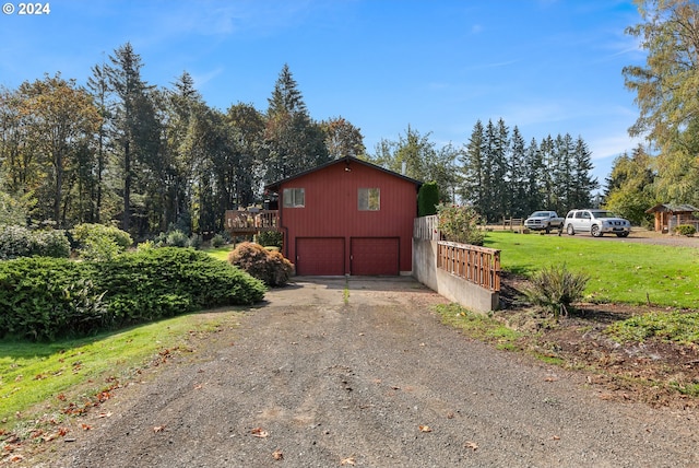 view of side of property with a garage and a lawn