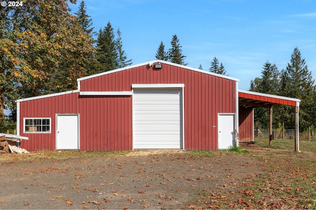 garage featuring an outbuilding