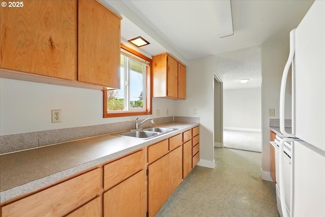 20125 SW Rachelle Ct, Beaverton, OR 97078 - kitchen with freestanding refrigerator, a sink, baseboards, light countertops, and light floors