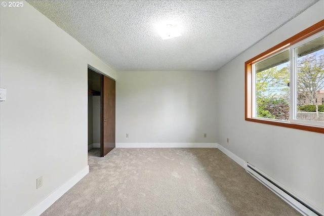 20125 SW Rachelle Ct, Beaverton, OR 97078 - spare room featuring a baseboard heating unit, a textured ceiling, light colored carpet, and baseboards