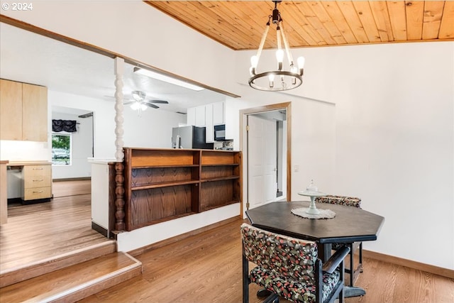 dining space featuring wood ceiling, ceiling fan with notable chandelier, and light hardwood / wood-style floors