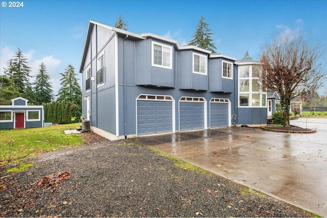 view of property exterior with central AC and a garage