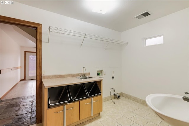 laundry room with washer hookup, light tile patterned floors, sink, and electric dryer hookup