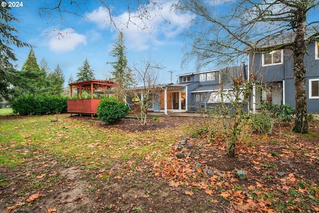 rear view of property featuring a yard