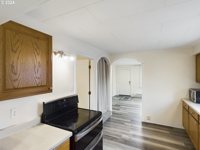 kitchen featuring black electric range, a baseboard heating unit, and light hardwood / wood-style flooring