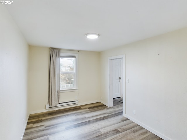 spare room with light hardwood / wood-style flooring and baseboard heating