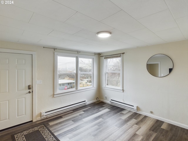 entrance foyer with a baseboard radiator and hardwood / wood-style flooring