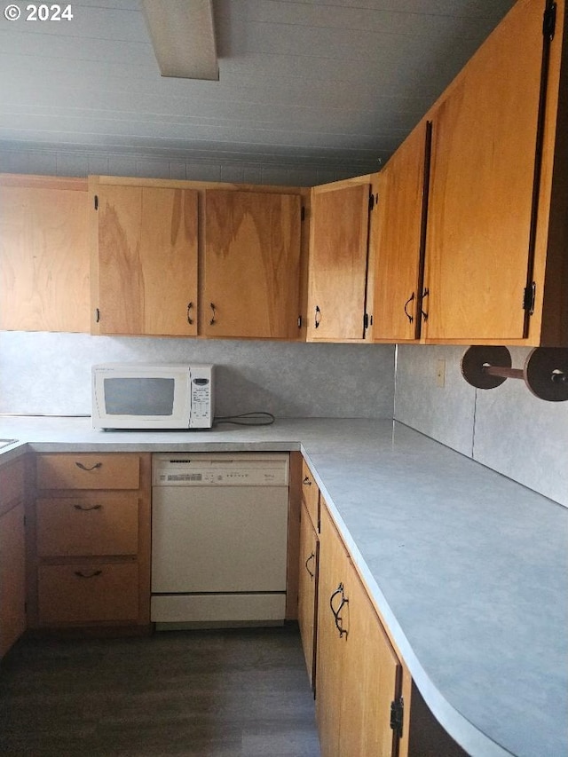 kitchen featuring decorative backsplash, dark wood-type flooring, and white appliances