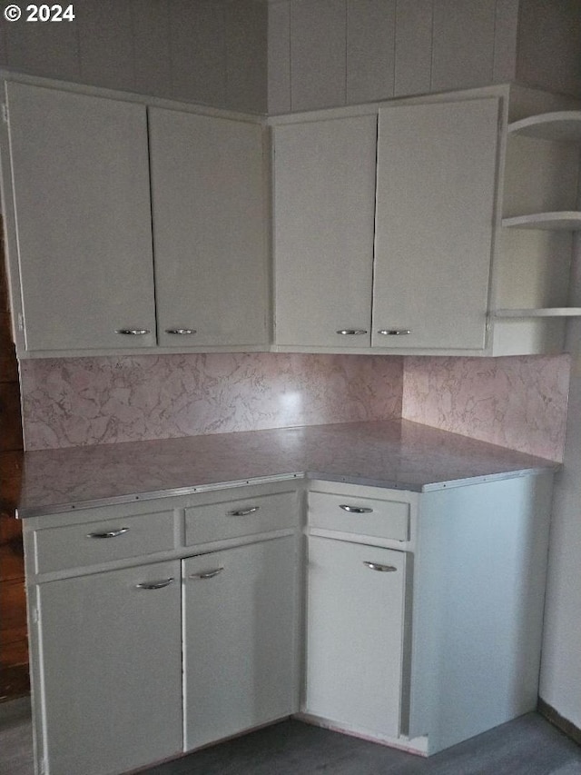 kitchen with white cabinets and backsplash