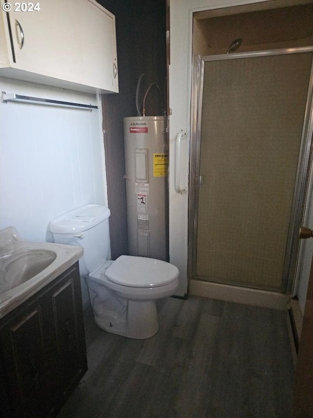 bathroom with vanity, electric water heater, hardwood / wood-style flooring, and an enclosed shower