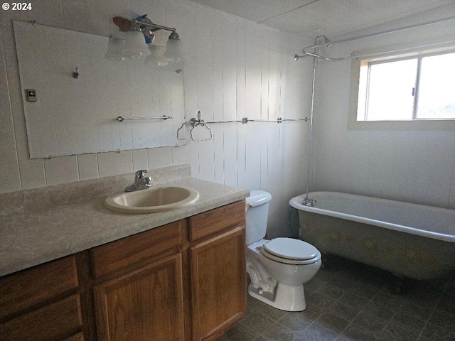 bathroom with a washtub, toilet, and vanity