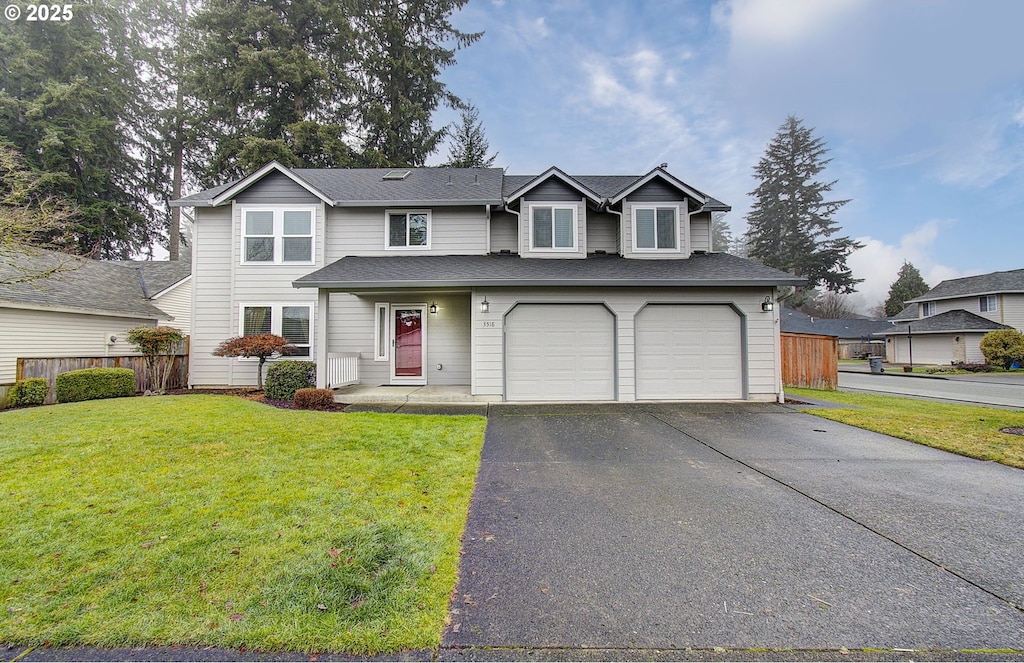 view of property featuring a garage and a front yard