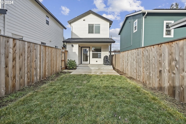 back of property featuring a patio and a lawn