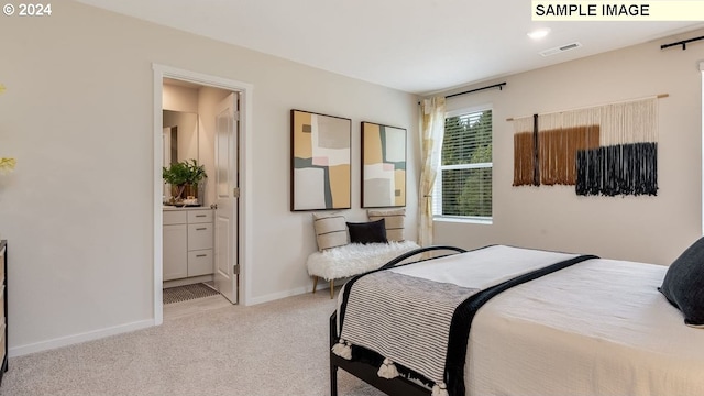 carpeted bedroom with ensuite bath