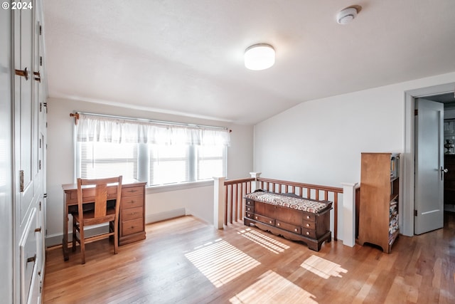 bedroom featuring light hardwood / wood-style floors and vaulted ceiling