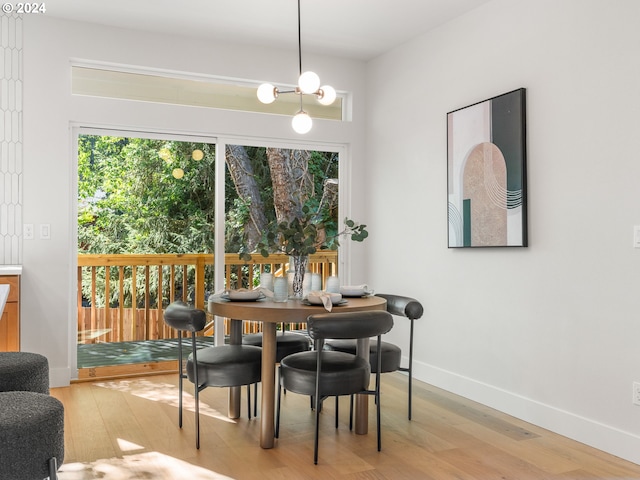 dining room featuring a notable chandelier and light hardwood / wood-style floors