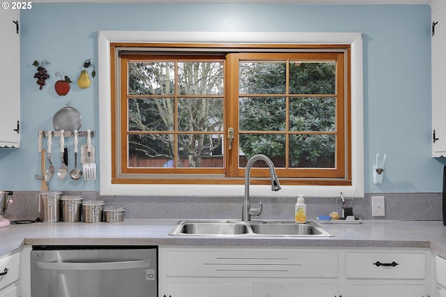 kitchen featuring white cabinetry, dishwasher, and sink