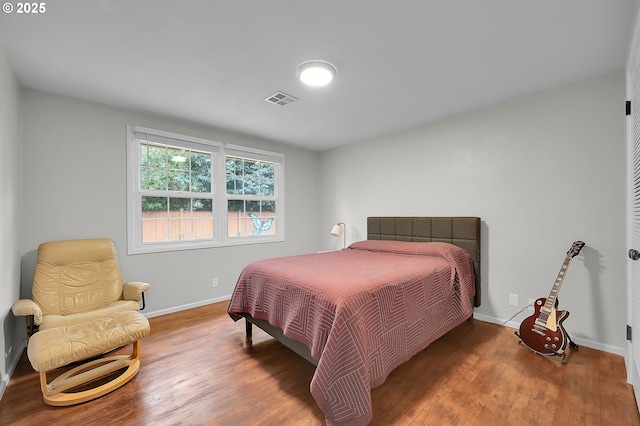 bedroom with wood-type flooring