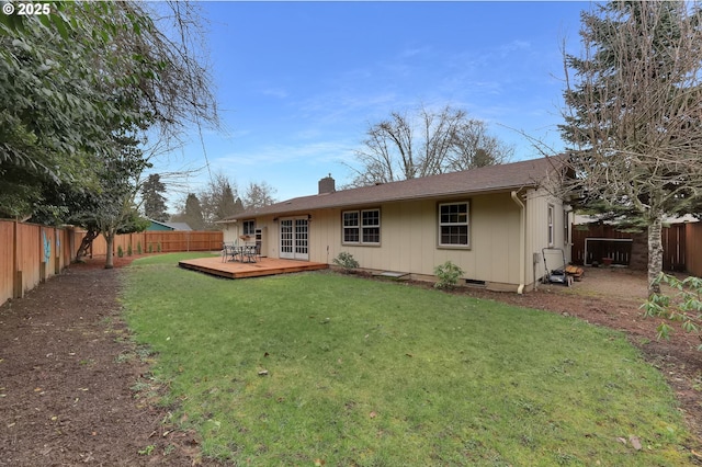 rear view of property with a yard and a deck