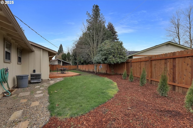 view of yard with central AC unit and a deck