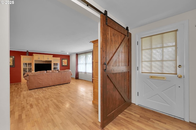 interior space with a barn door and light wood-type flooring