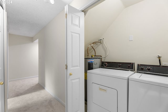 laundry area with independent washer and dryer, light carpet, and a textured ceiling