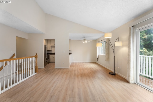 interior space featuring light hardwood / wood-style floors, high vaulted ceiling, plenty of natural light, and ceiling fan