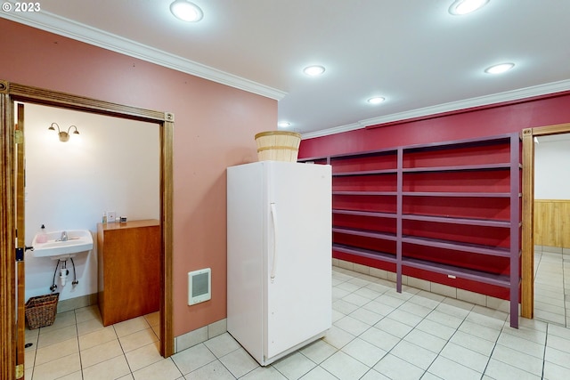 kitchen with built in shelves, crown molding, white fridge, and light tile flooring