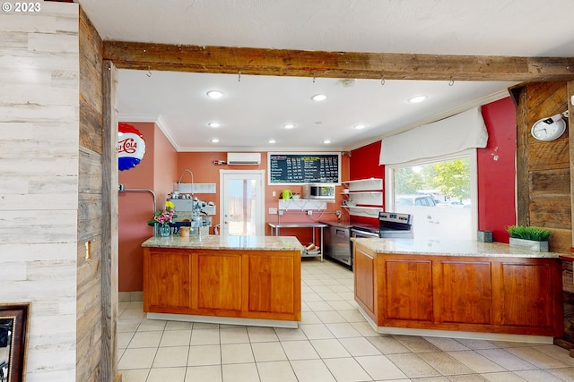 kitchen featuring appliances with stainless steel finishes, light stone counters, light tile floors, and a wall mounted air conditioner