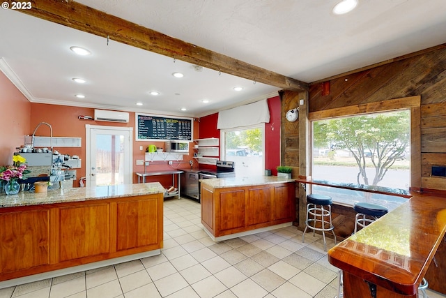 kitchen featuring kitchen peninsula, light stone countertops, and beamed ceiling