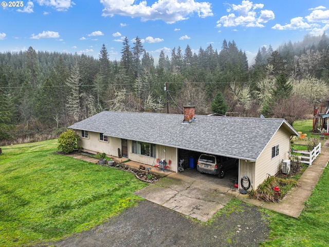 ranch-style house featuring a carport, covered porch, central air condition unit, and a front yard