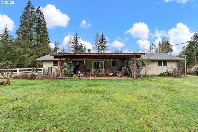 rear view of house with a yard and a patio area