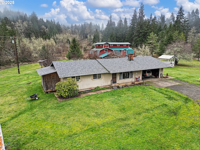 ranch-style home with covered porch, a front lawn, and a carport