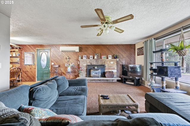 carpeted living room featuring a wealth of natural light, wood walls, a wall mounted air conditioner, and a wood stove