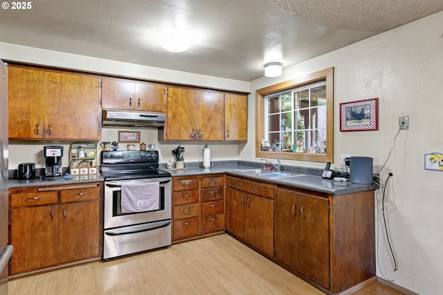 kitchen with sink, a textured ceiling, electric range, and light wood-type flooring