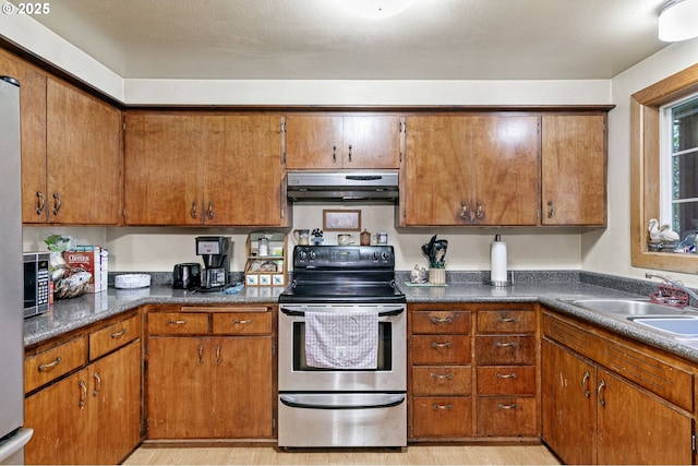 kitchen featuring extractor fan, electric stove, light hardwood / wood-style floors, and sink