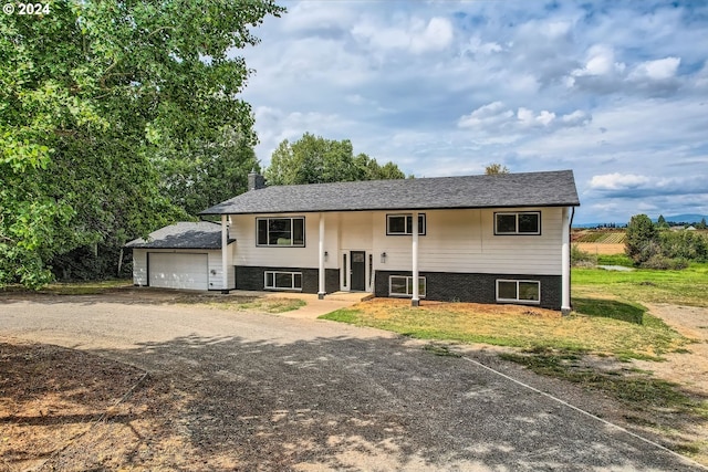 bi-level home featuring a garage and a front yard